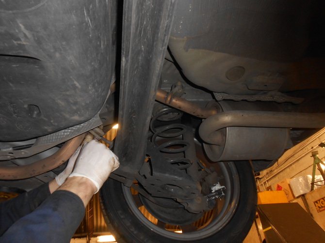 Underside mechanical inspection, typical of suspension and exhaust work
