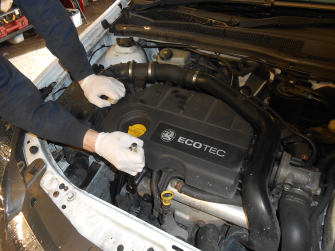 Close-up of work around a Vauxhall engine bay